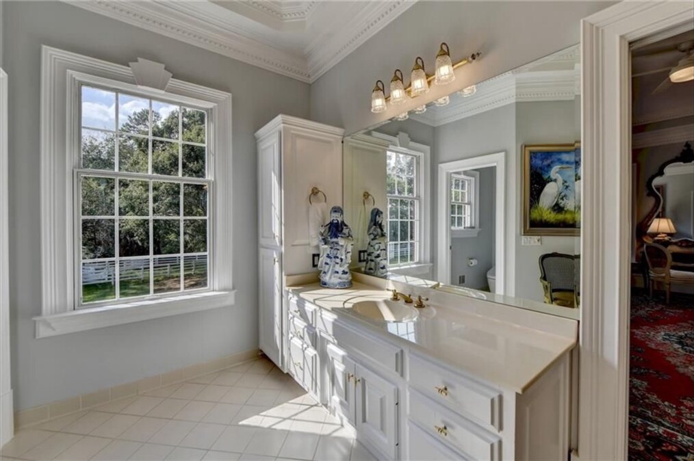 Primary bathroom before renovation, window and vanity