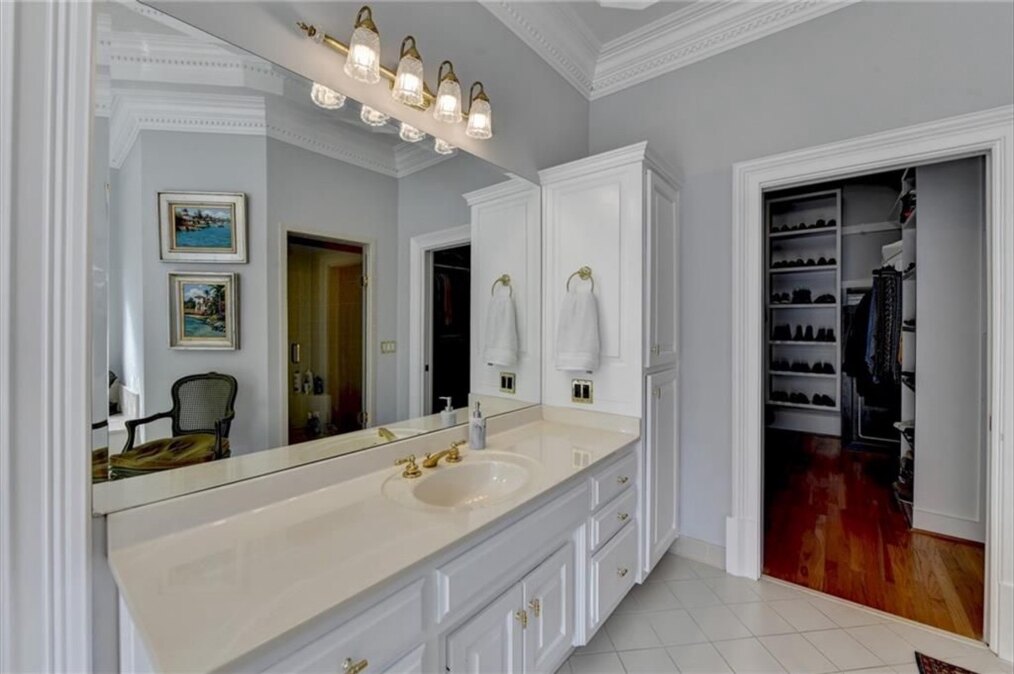 Primary bathroom before renovation, long vanity